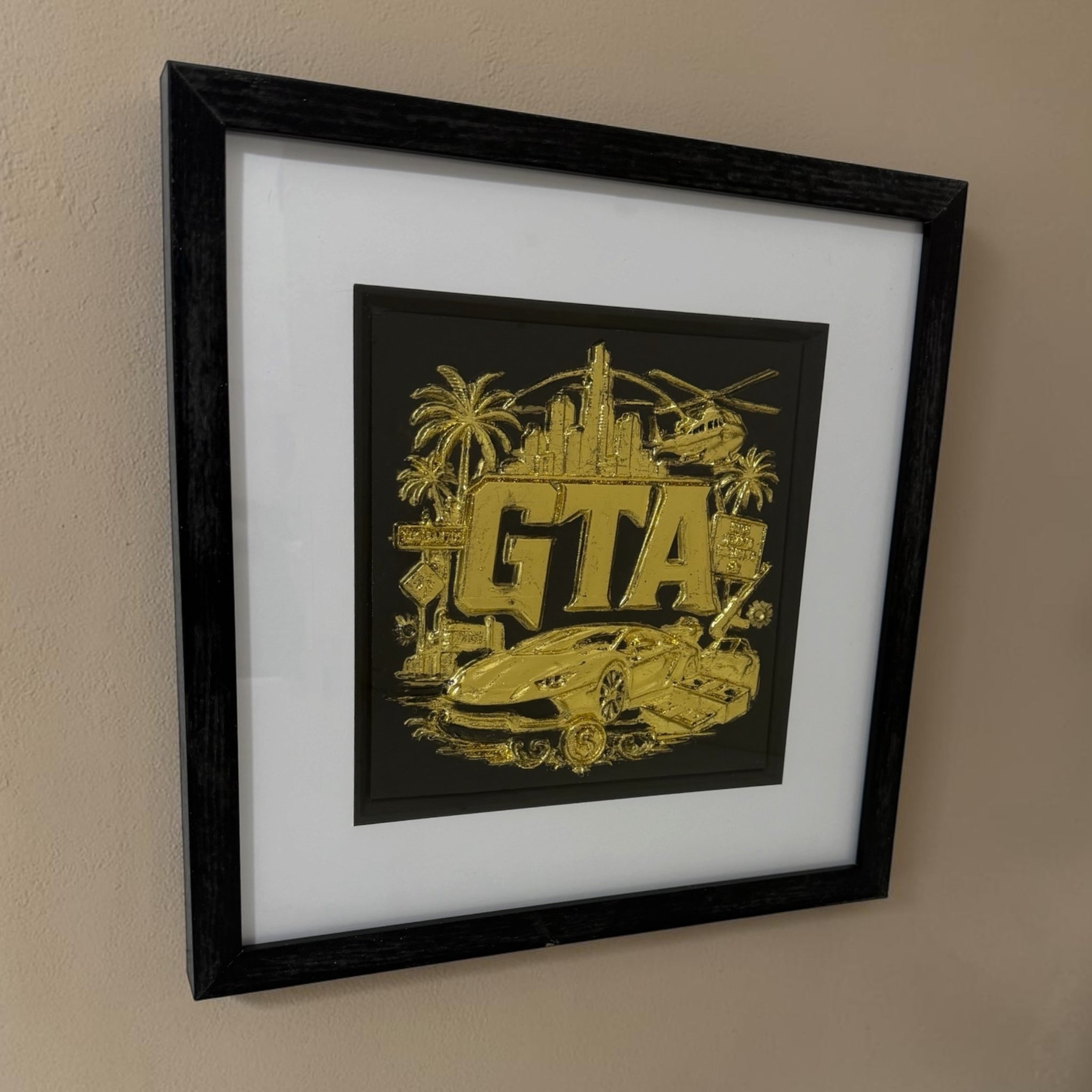 Angled view of gold 3D grand theft auto inspired gaming artwork in a black square frame with white mount and black inner surround.