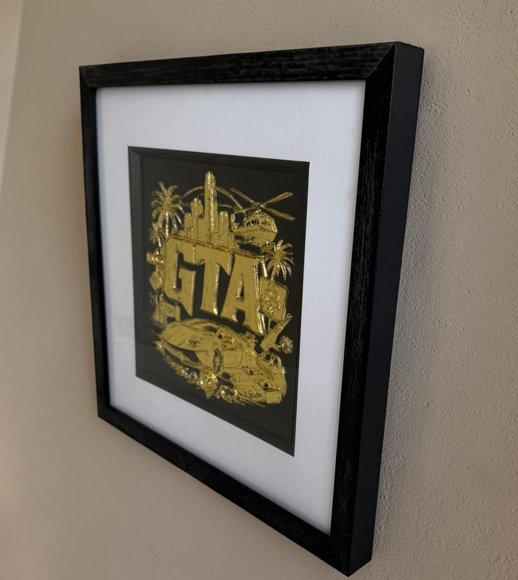 Close-up of raised gold gaming artwork showing metallic shine, depth and black framed presentation.