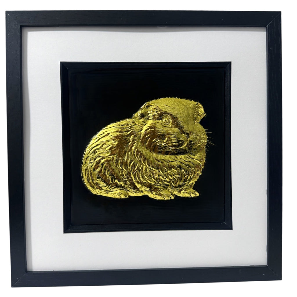 A luxury 3D relief sculpture of a Guinea Pig finished in metallic gold leaf, highlighting the textured fur details against a black background.