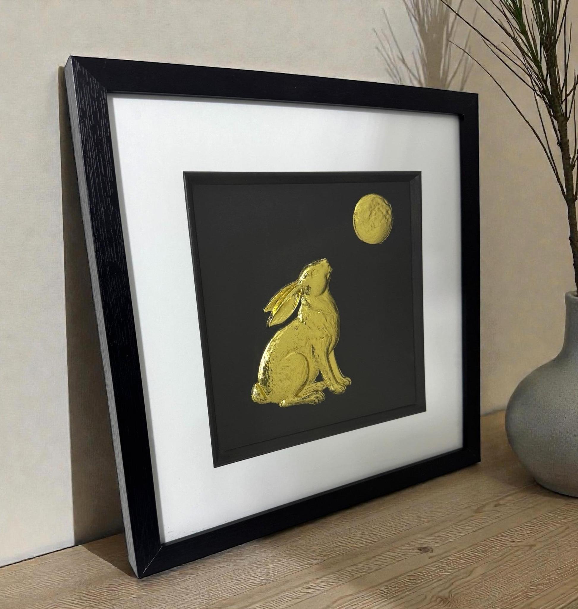 A gold leaf Hare and Moon art piece displayed on a sideboard, adding a touch of ancient folklore and luxury to the room.