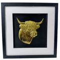 Front-facing gold leaf Highland cow head wall art with black background and white mount