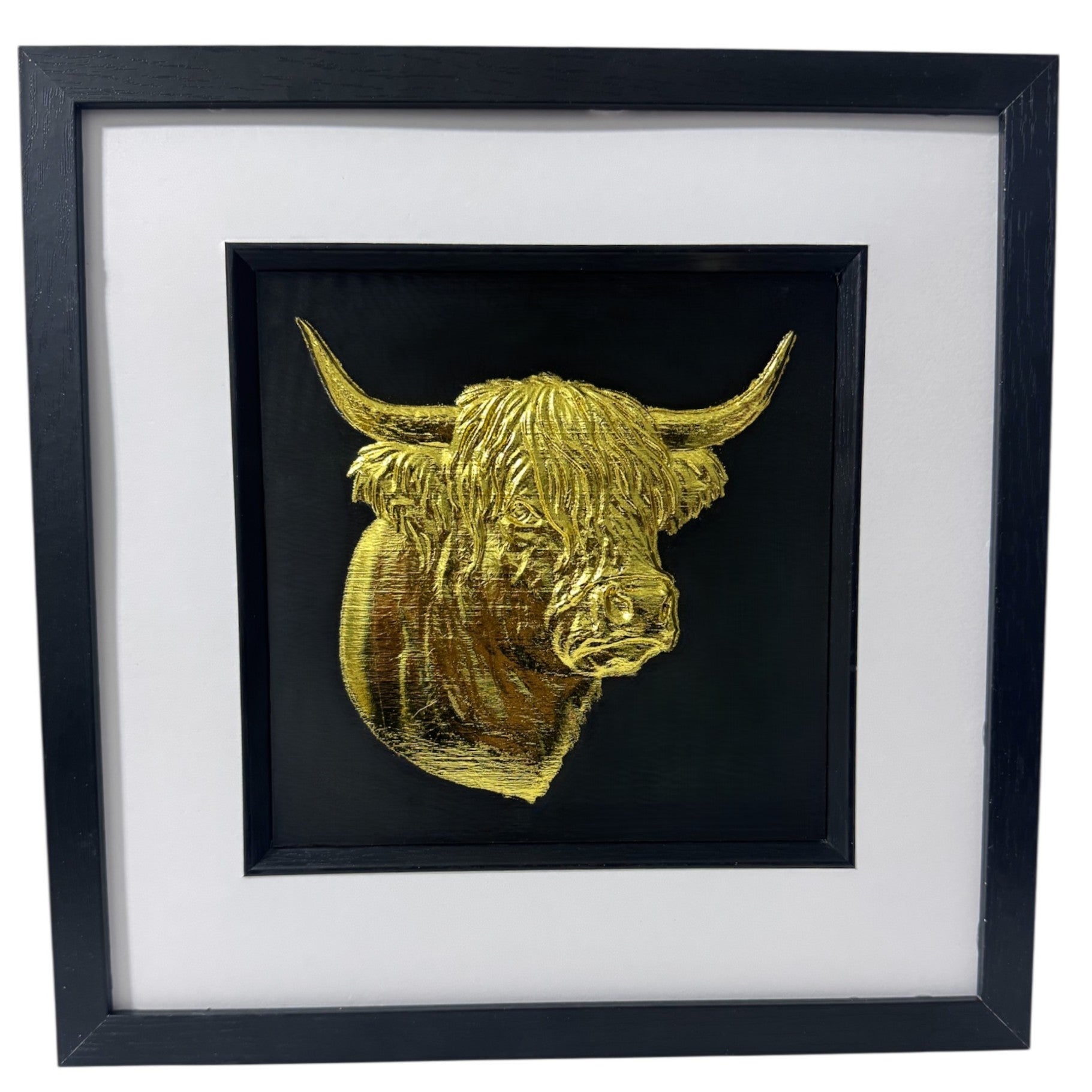Front-facing gold leaf Highland cow head wall art with black background and white mount