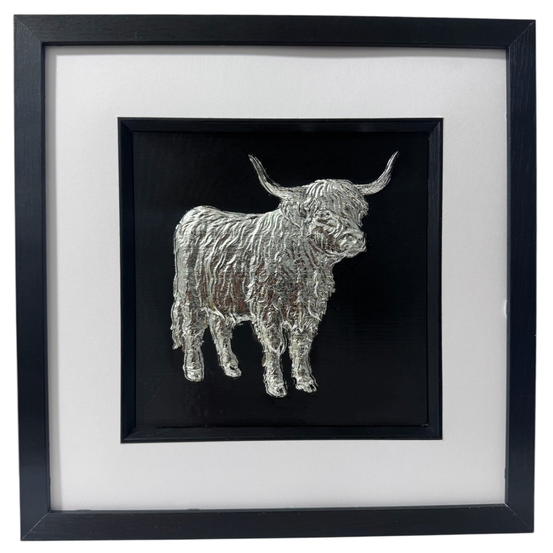 Silver full body Highland cow in raised relief, black background, black square box frame, wide white mount, black inner surround.