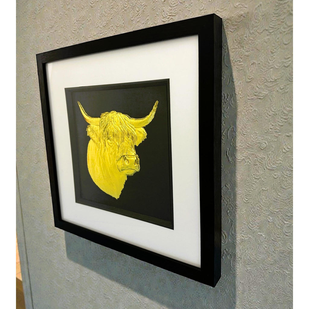 Angled wall-mounted view of gold leaf Highland cow head framed artwork