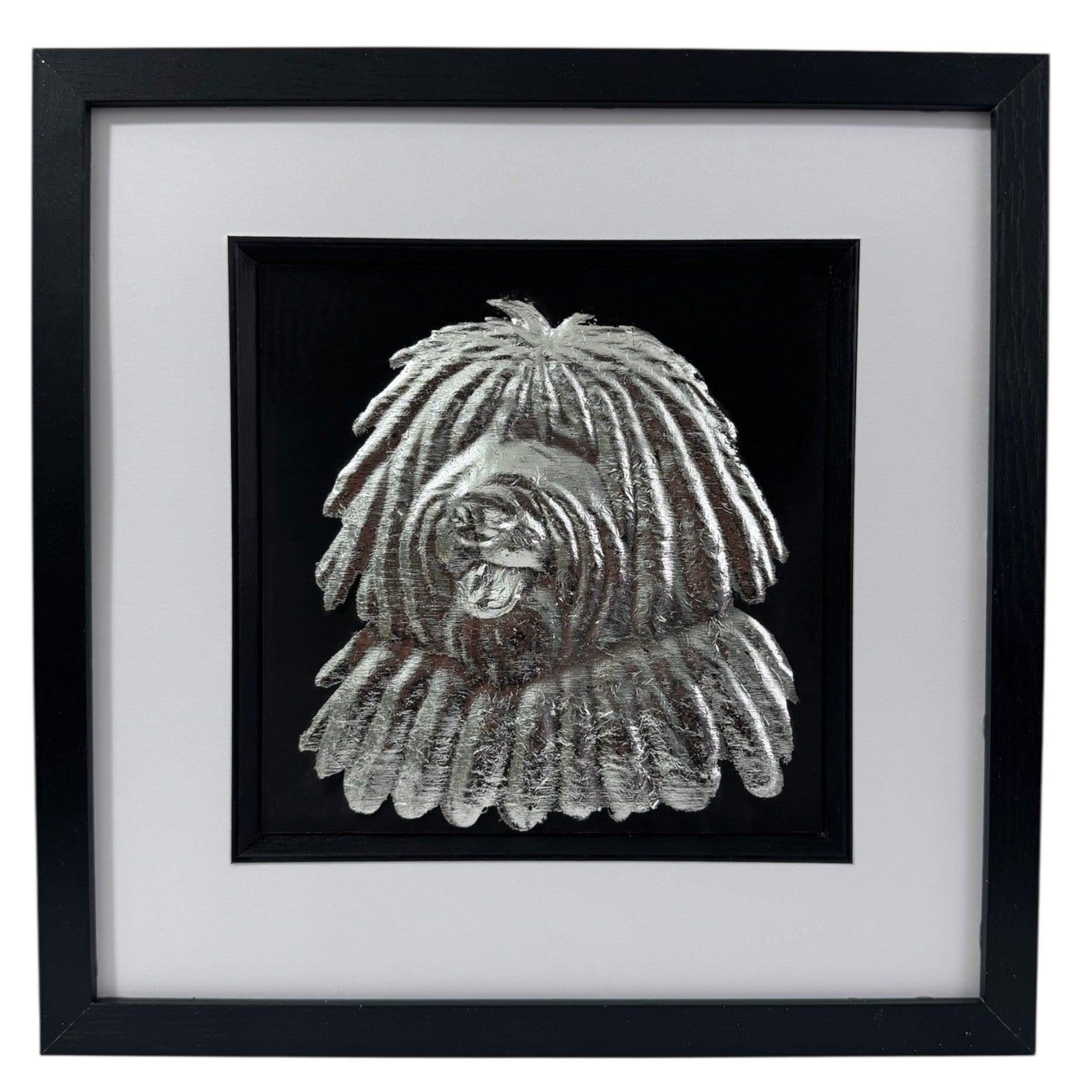 Hungarian Puli framed wall art showing a sculpted dog portrait with corded coat texture in silver leaf, set on a black background with white mount and black wooden frame
