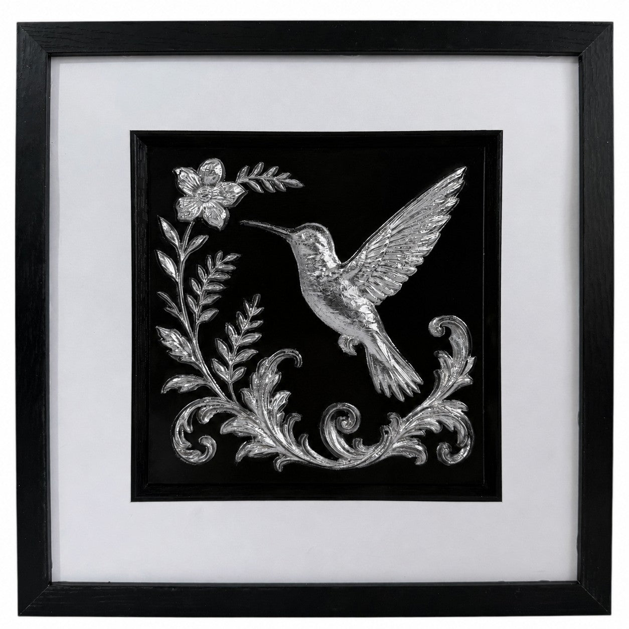 Silver 3D hummingbird artwork with flower and curling leaves in a black frame with white mount