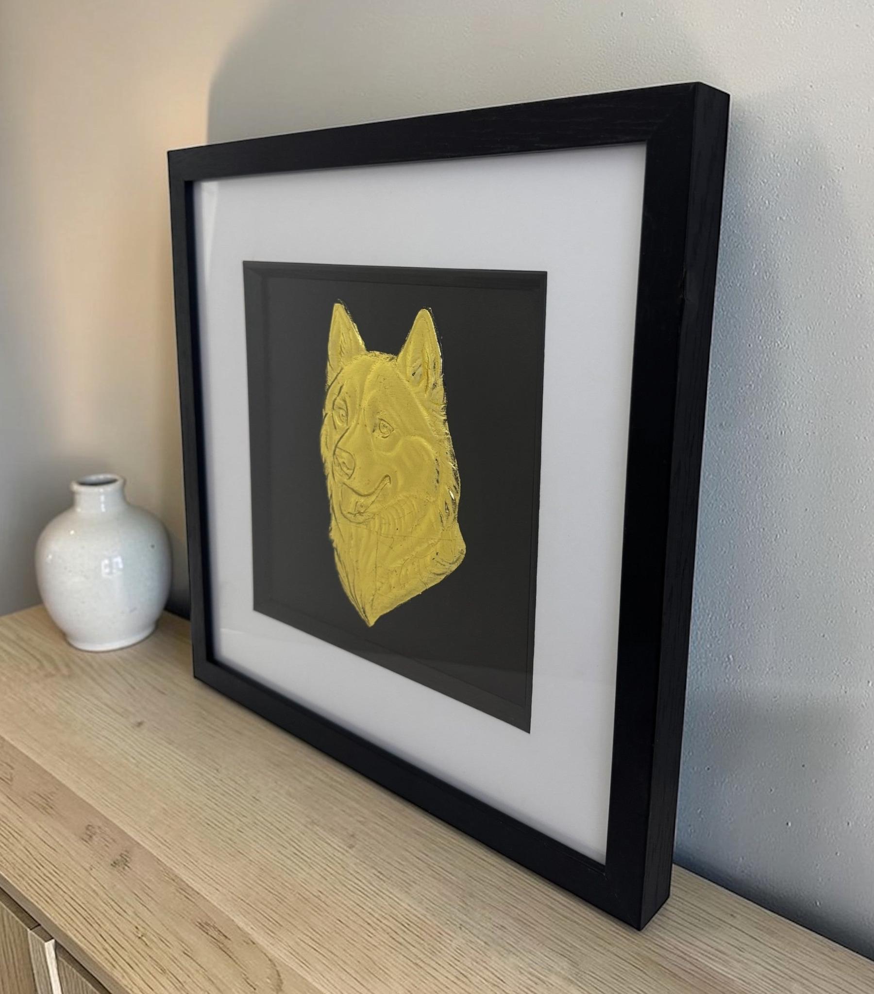 Siberian Husky framed wall art in gold leaf viewed at an angle, displayed in a black wooden frame with white mount
