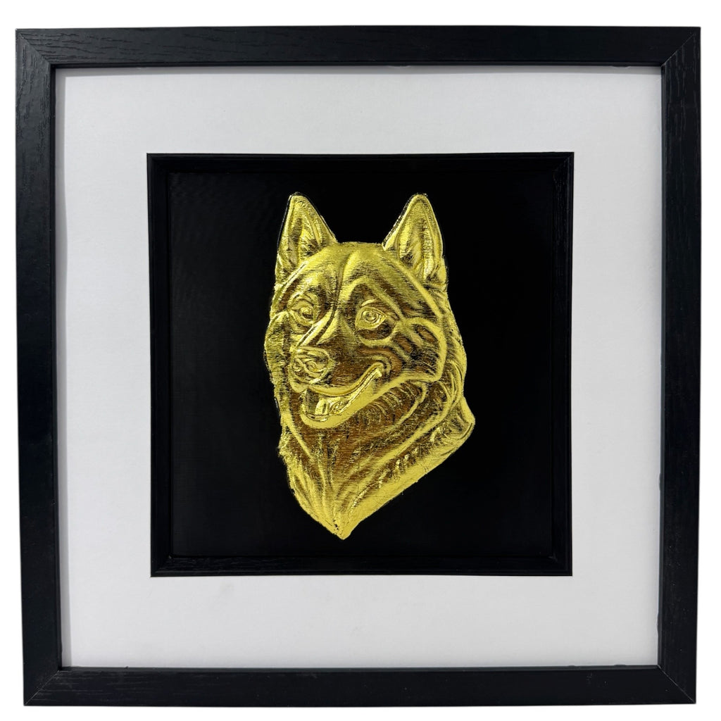 Siberian Husky snow dog framed wall art showing a sculpted dog portrait in gold leaf, set on a black background with white mount and black wooden frame
