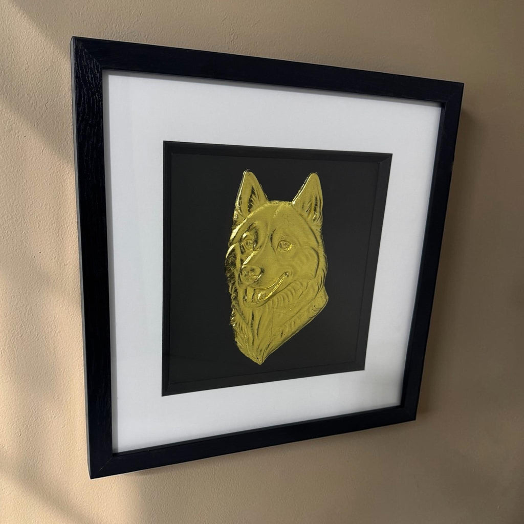 Siberian Husky framed wall art in silver leaf mounted on a wall, with black wooden frame, white mount, and black background
