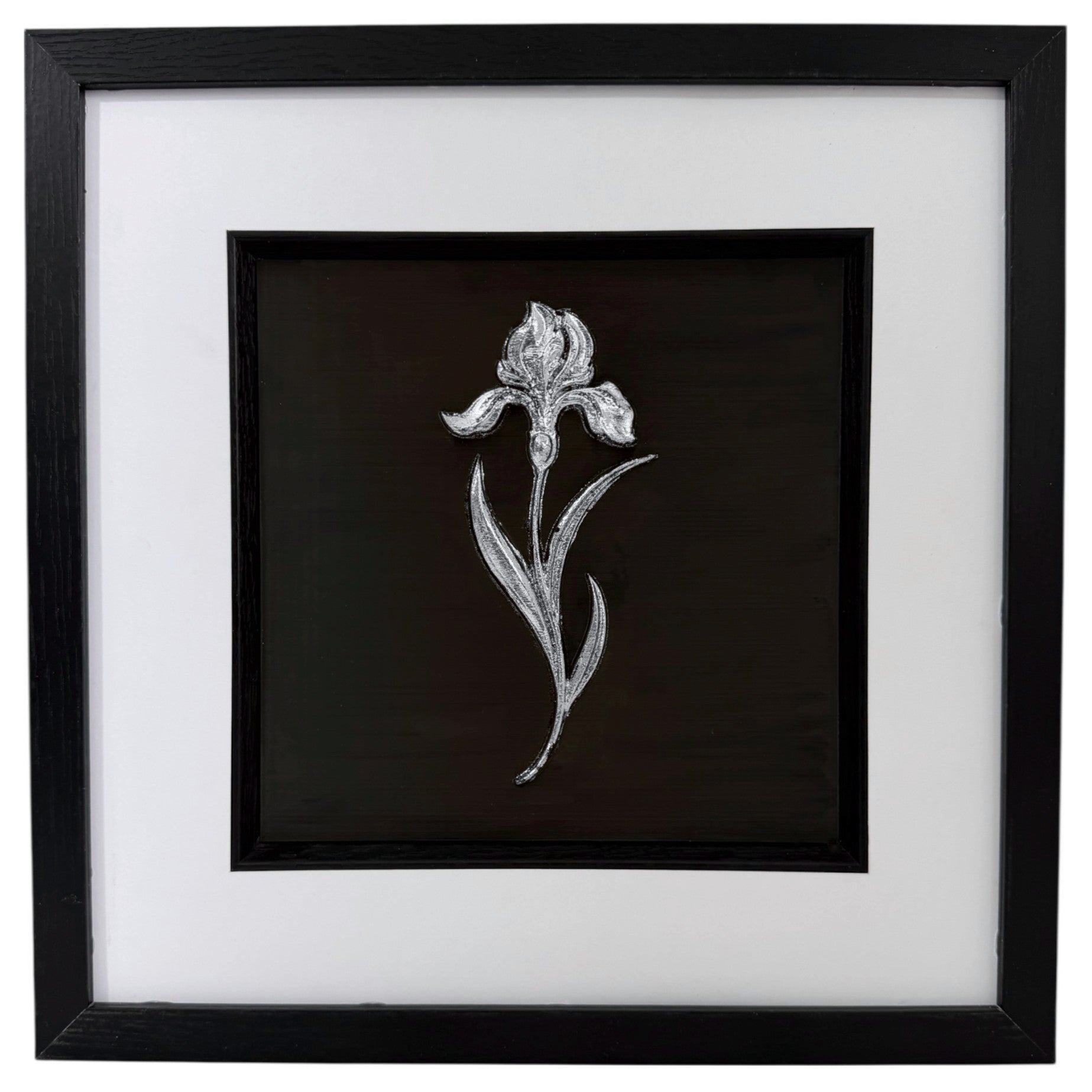 Silver iris raised relief in a black frame with white mount, black inner surround, and glass front on a white background.
