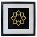 Gold framed Islamic geometric 8 point star relief on a black background with a wide white mount and black inner surround