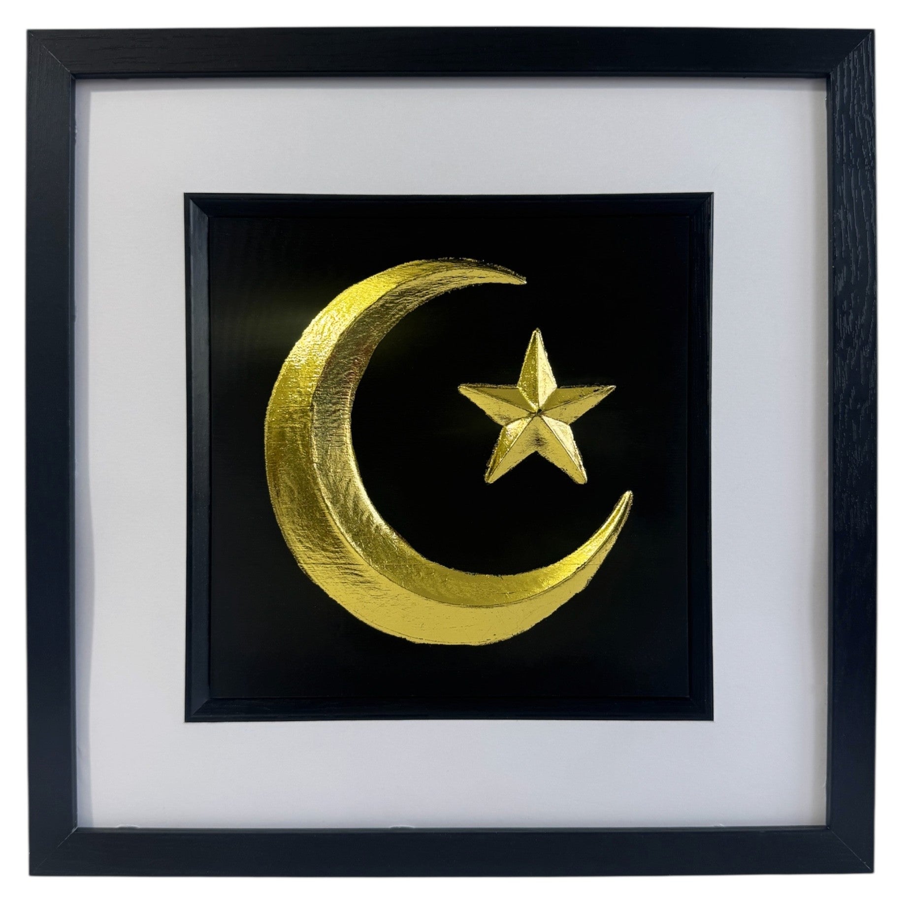 Gold crescent moon and star wall art on black background with white mount