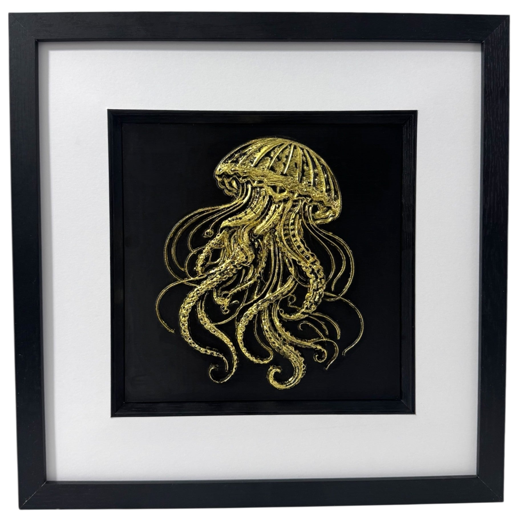 Framed 3D jellyfish wall art in gold leaf on black background with white mount, sea life wall art close-up.