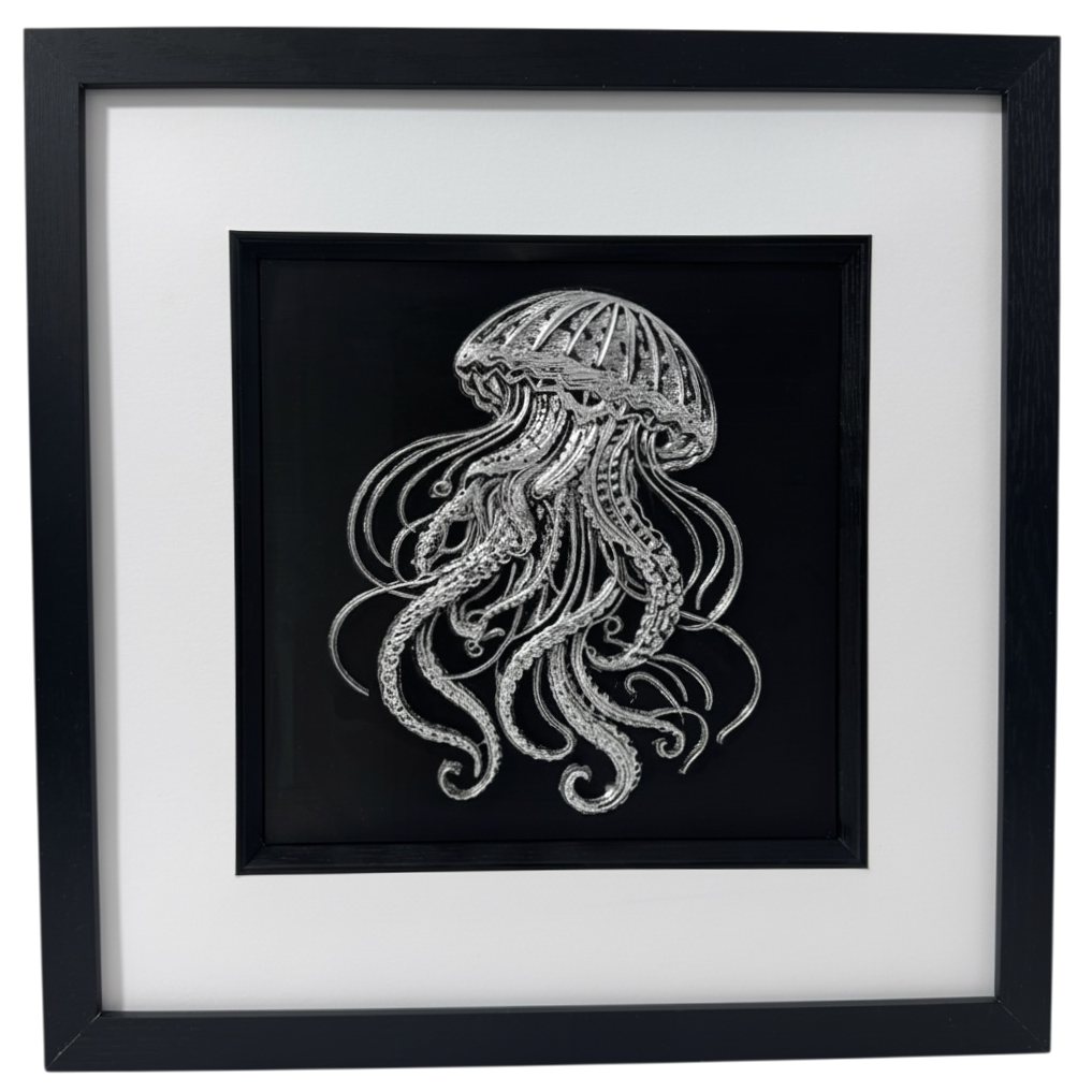 Framed 3D jellyfish wall art in silver leaf on black background with white mount, marine life wall art