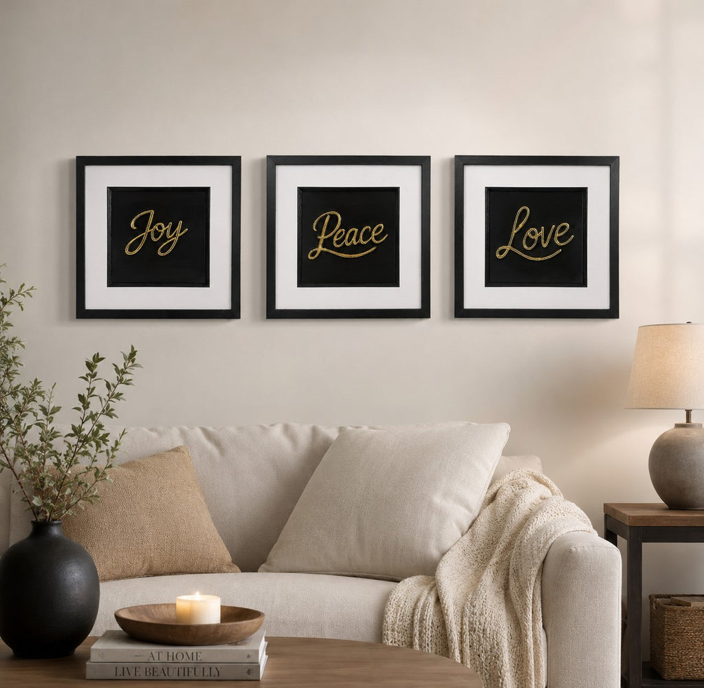 Gold Joy Peace Love 3D framed wall art trio styled above a cream sofa in a warm neutral living room