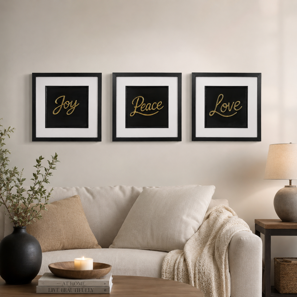 Gold Joy Peace Love 3D framed wall art trio styled above a cream sofa in a warm neutral living room