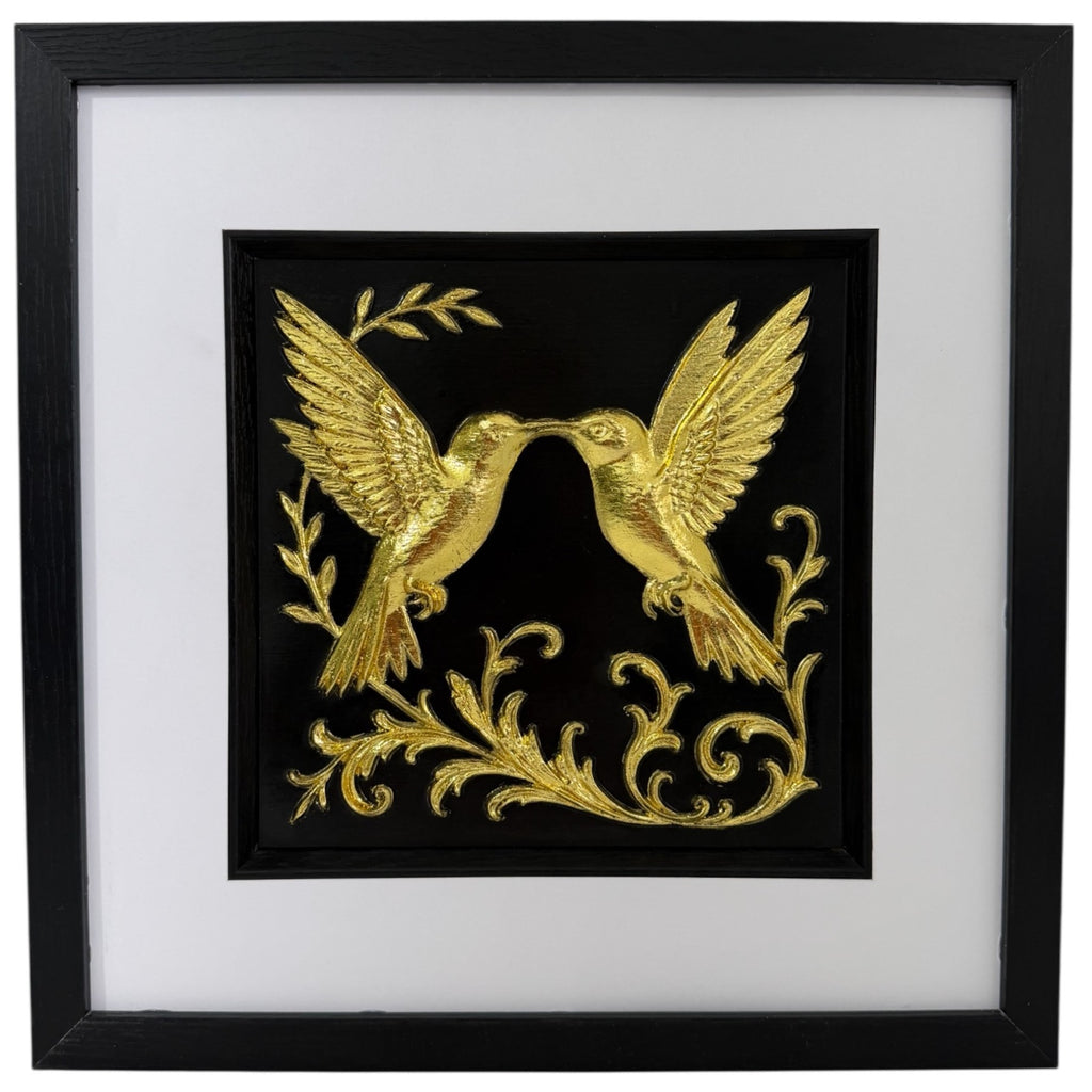 Framed 3D wall art of kissing hummingbirds featuring a hand-gilded gold leaf finish on a black background. Modern romantic nature decor by JP Designs.