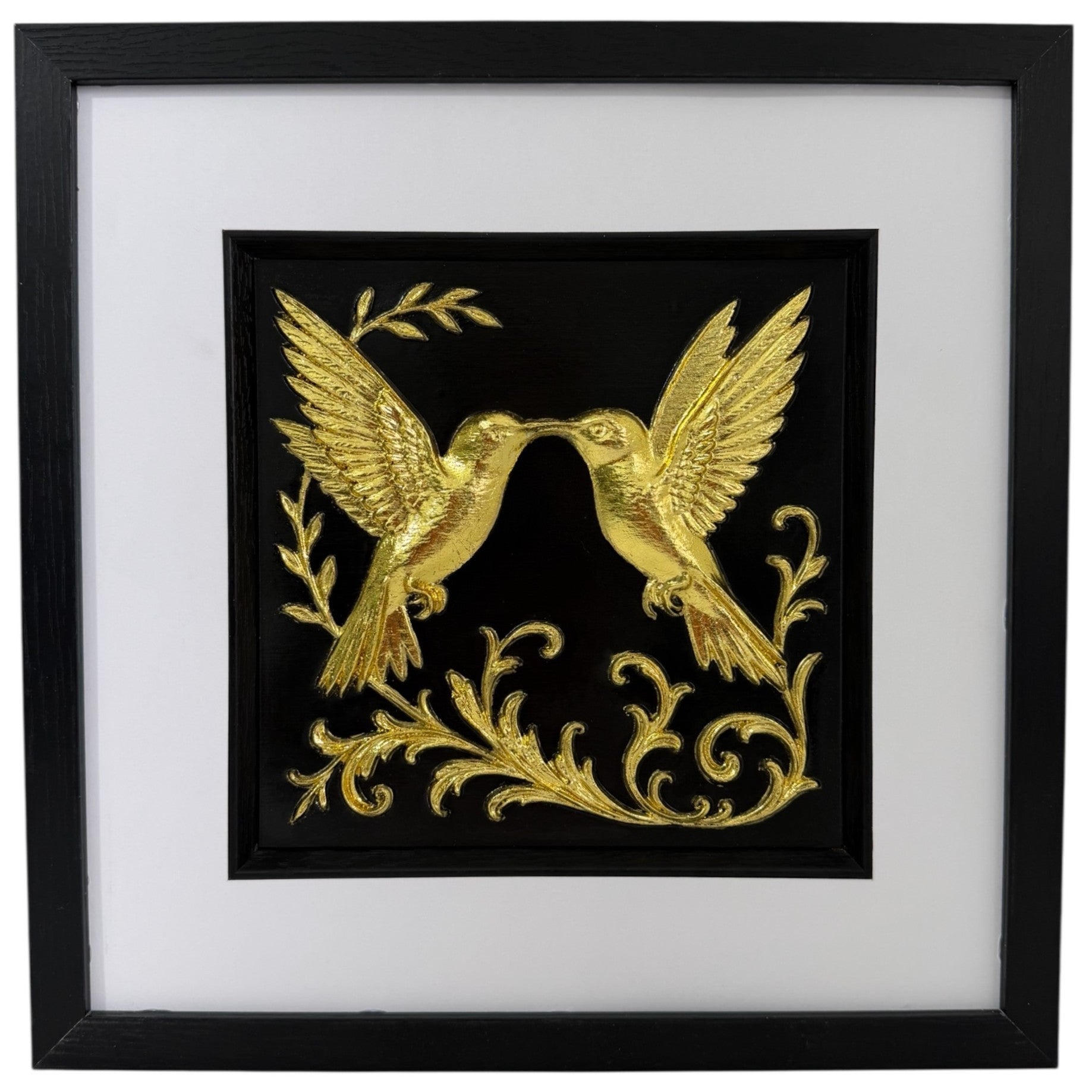 Framed 3D wall art of kissing hummingbirds featuring a hand-gilded gold leaf finish on a black background. Modern romantic nature decor by JP Designs.