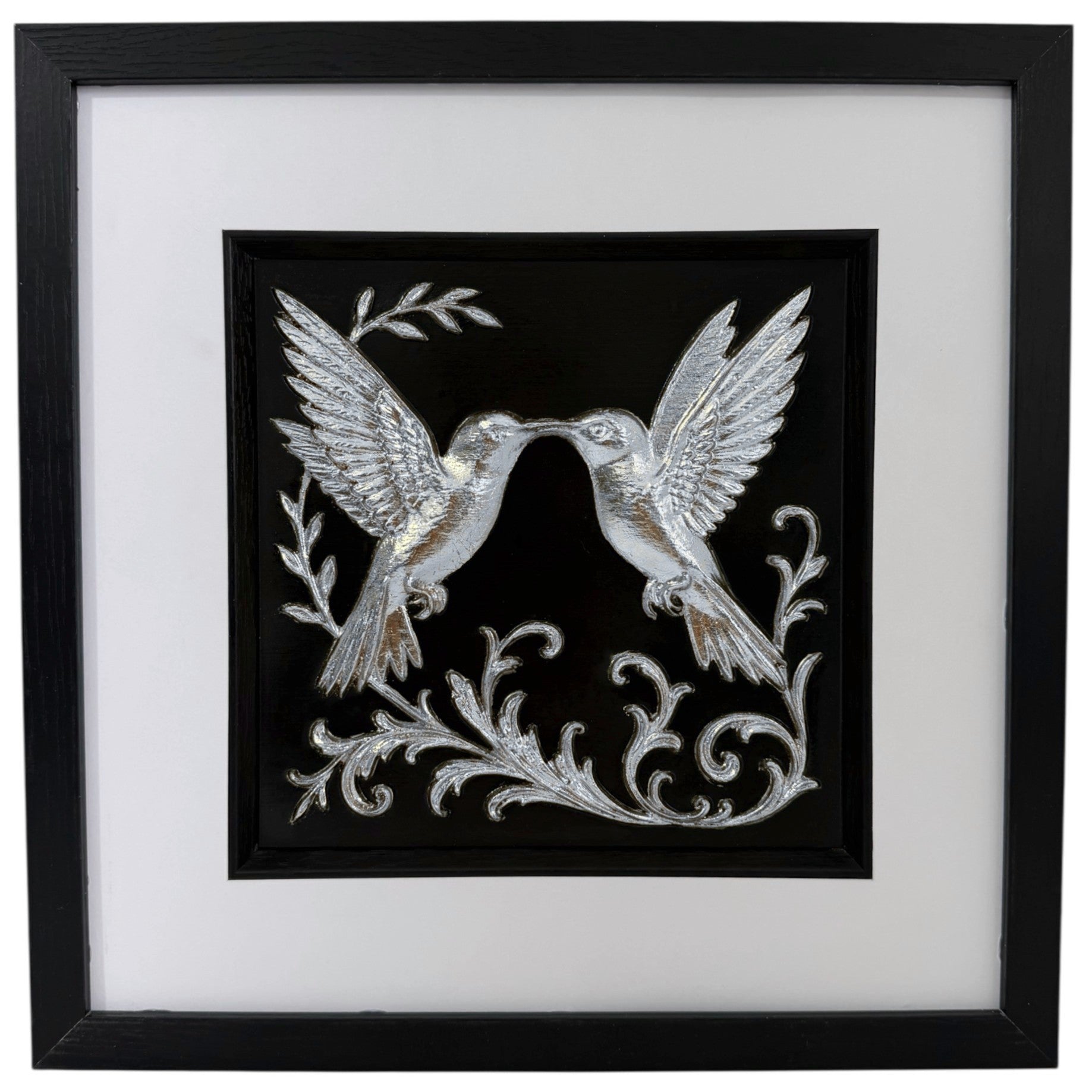 Silver leaf kissing hummingbirds 3D relief wall art in a black frame. Chrome-effect textured home decor for modern grey interiors.