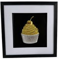 Gold and silver cupcake framed artwork with swirled icing, cherry and ribbed cupcake case.