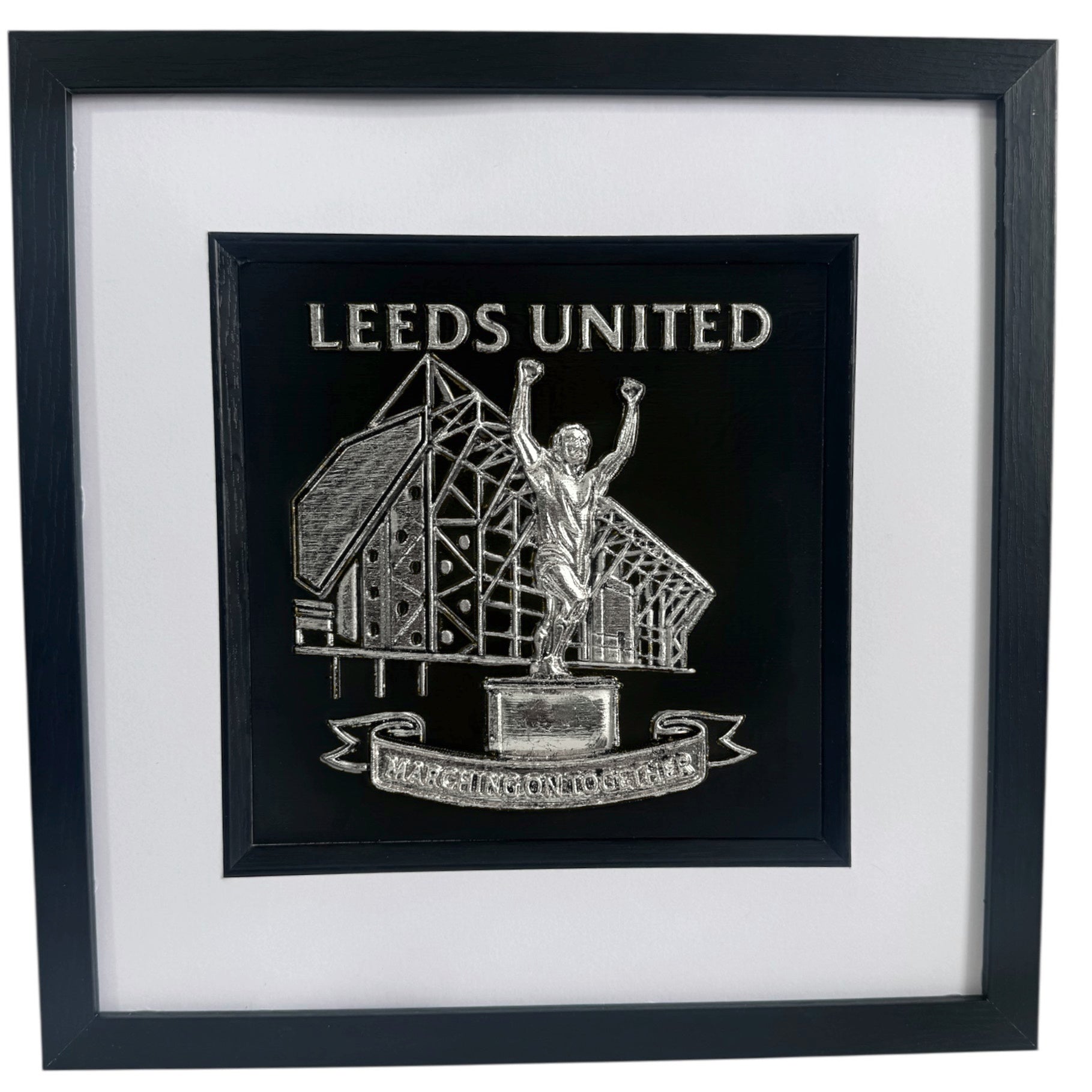 Front view of framed Leeds United stadium and Billy Bremner statue relief artwork in Silver Leaf with black box frame and white mount