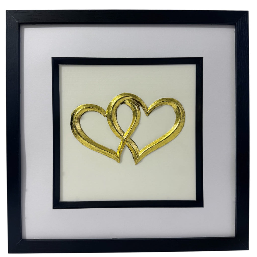 Front-facing gold leaf joined hearts framed wall art with white mount and Ivory background
