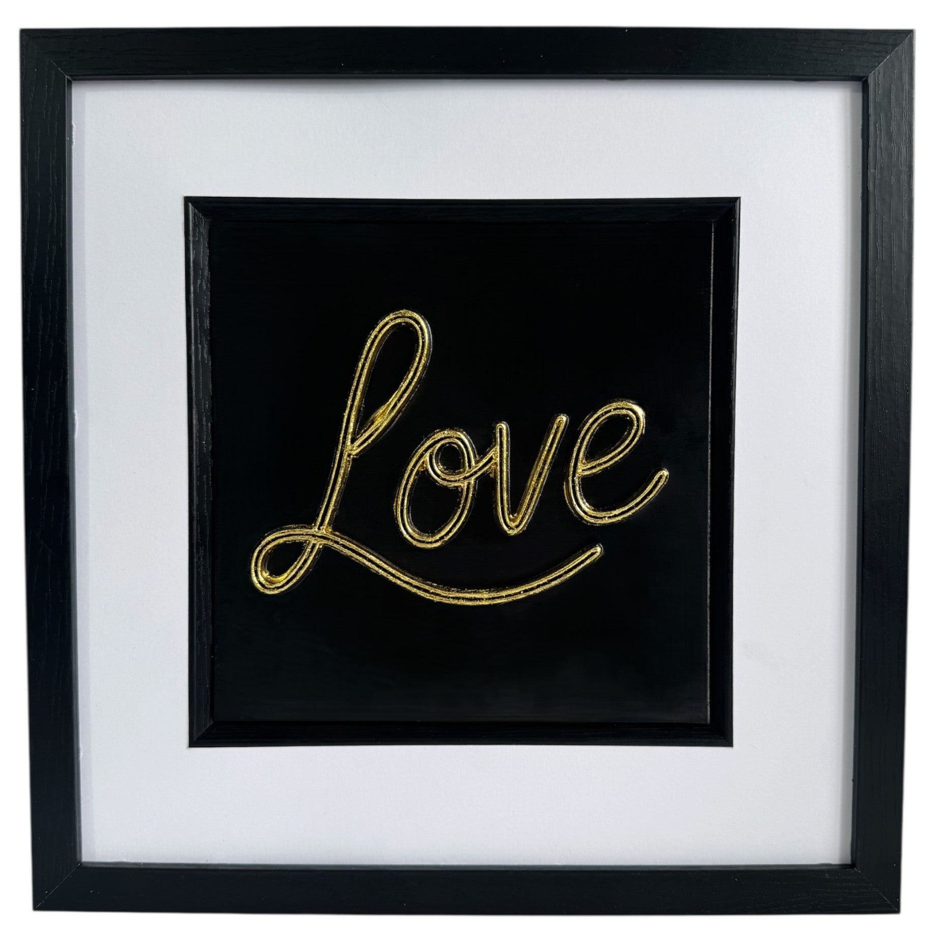 Front view of framed 3D Love sign in gold finish with wide white mount, black box frame, and glass front.