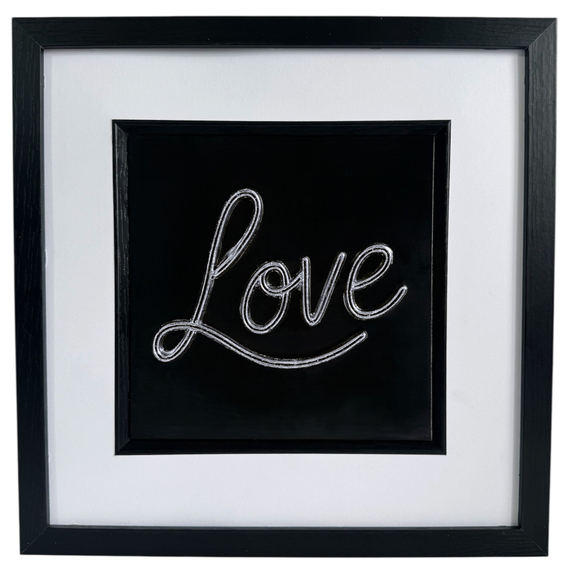 Front view of framed 3D Love sign in silver finish with wide white mount and black box frame.