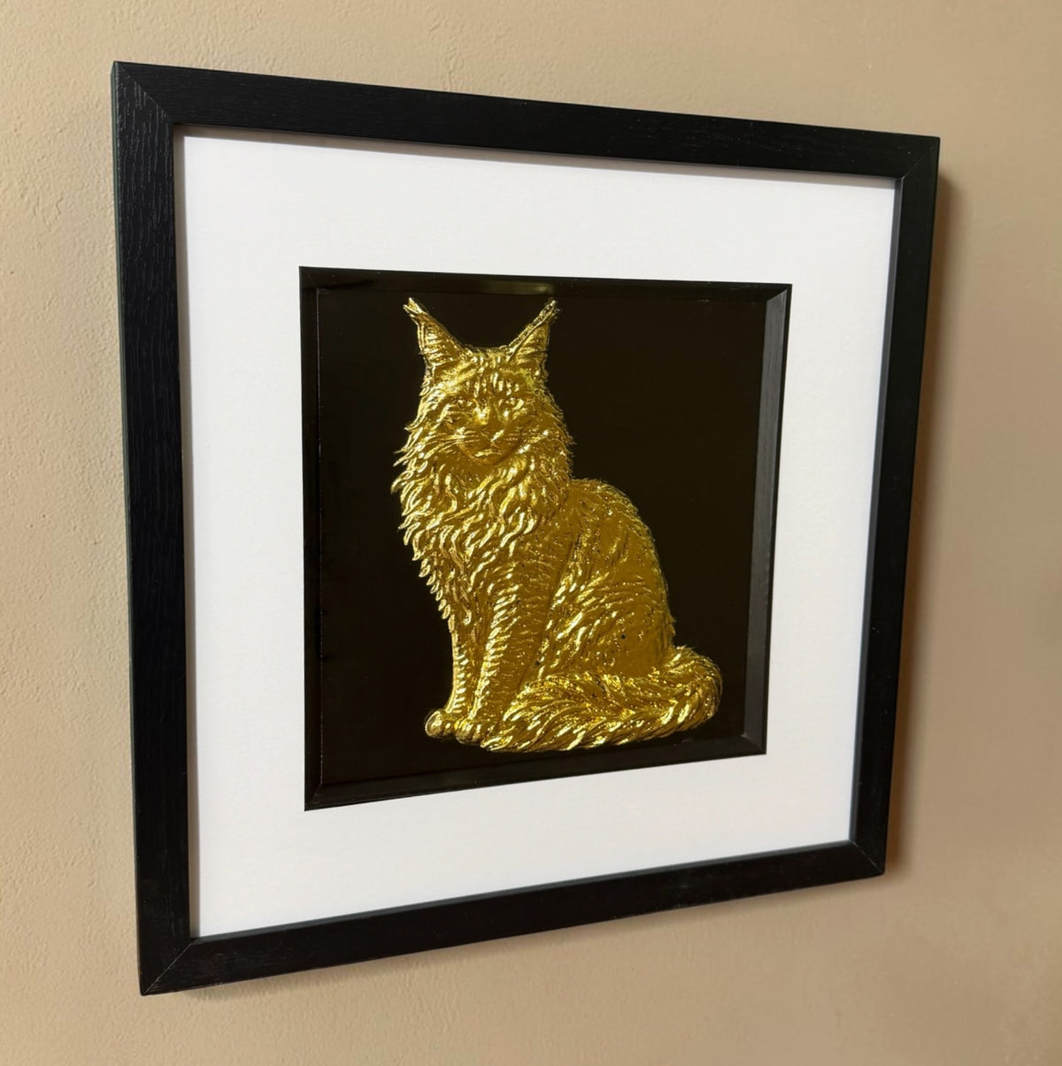 Gold Maine Coon 3D wall art hanging on a cream textured wall, viewed from the side to show the depth of the black box frame and the raised fur texture