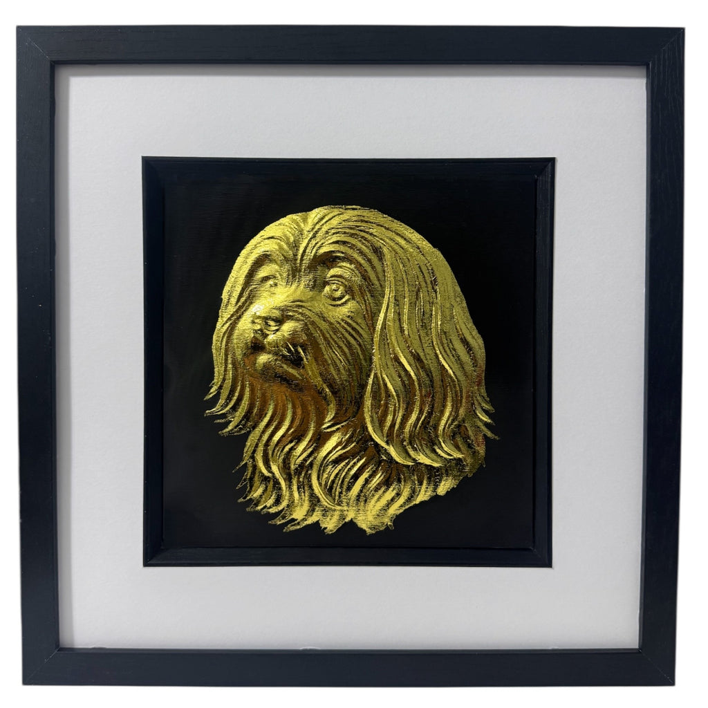 Maltese framed wall art in gold leaf shown front on with black wooden frame white mount and black background