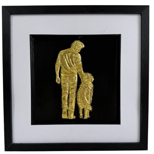 Gold finish framed 3D dog memorial gift with raised man and dog design, white mount and black frame.
