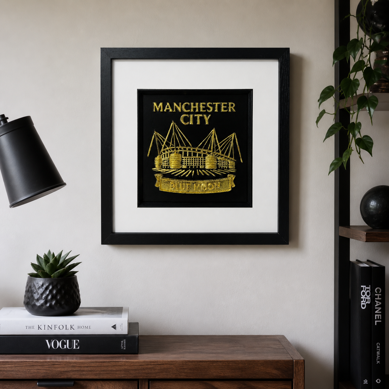 Lifestyle photo of Manchester City wall art displayed on a neutral wall above a wooden table with modern home decor.