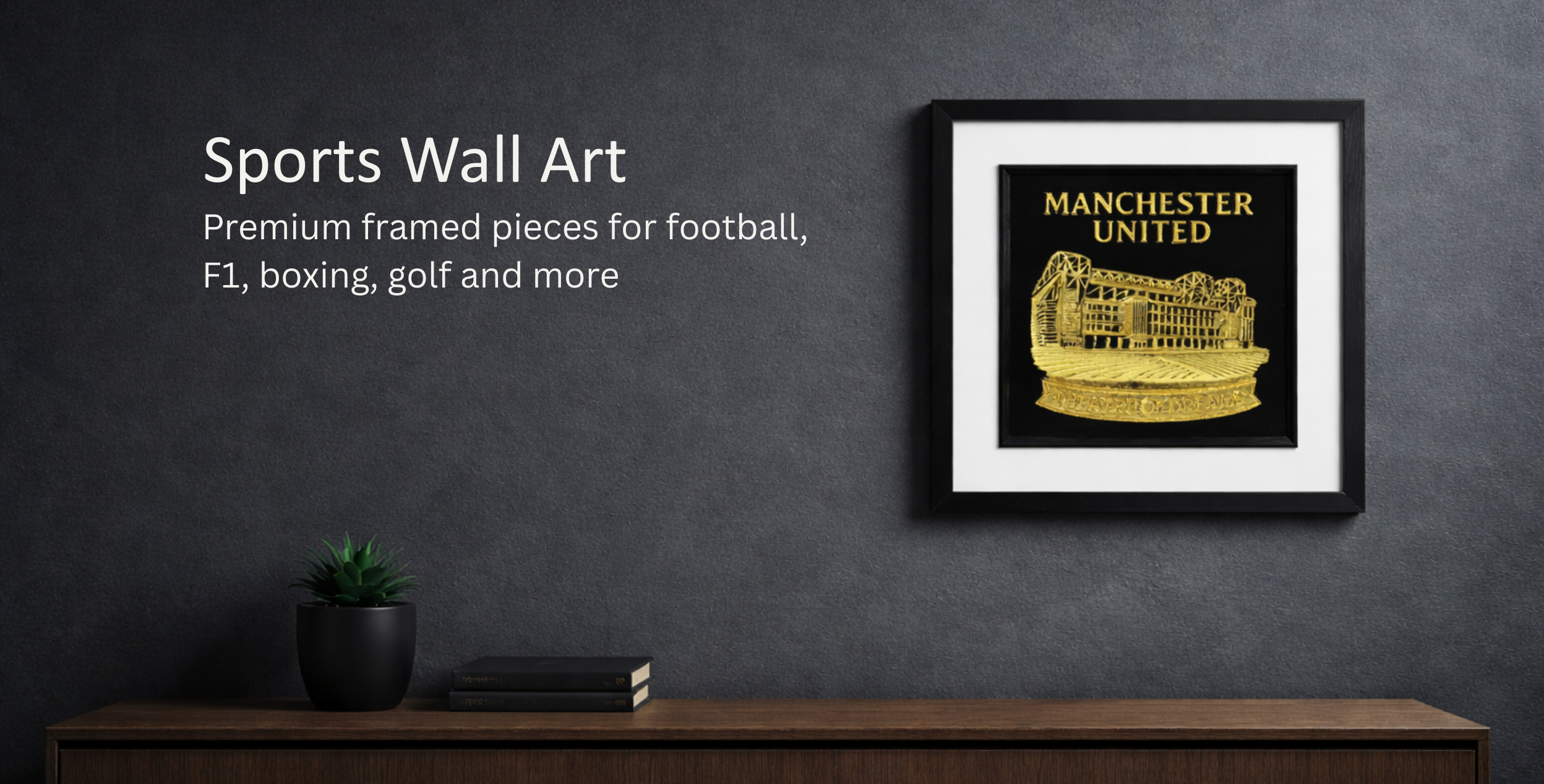 JP Designs sports wall art hero banner showing Manchester United framed gold relief wall art on a dark charcoal microcement wall above a walnut console, with clean negative space on the left for overlay text.
