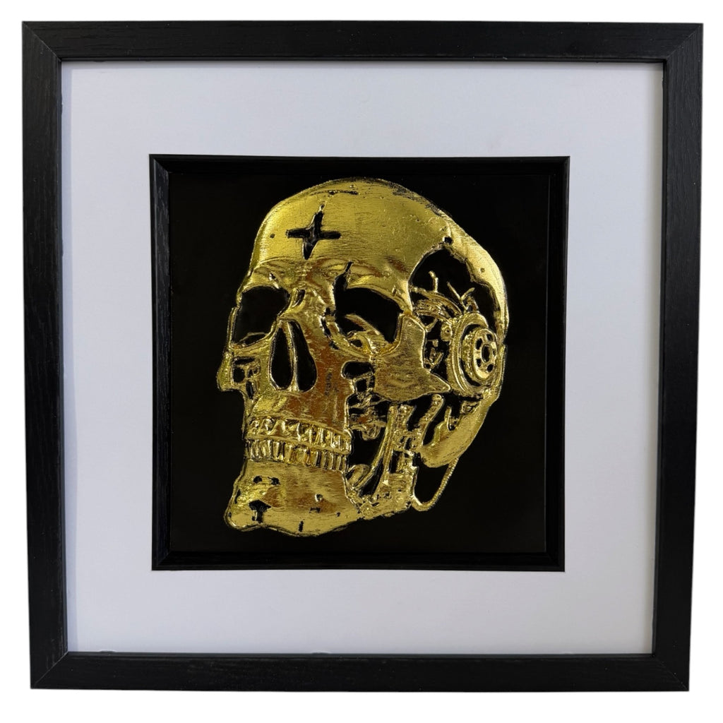 Gold leaf mechanical skull wall art framed on black background