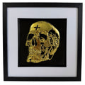 Gold leaf mechanical skull wall art framed on black background