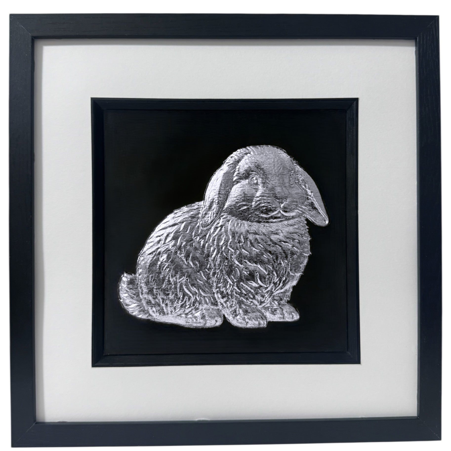 Framed Mini Lop rabbit 3D wall art in silver leaf, in a black wooden frame with white mount on a black background.