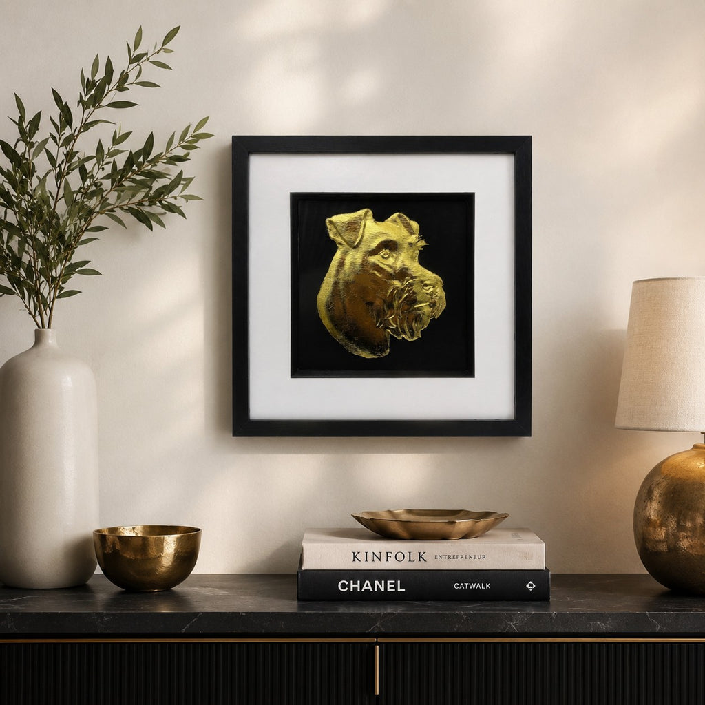 Miniature Schnauzer gold leaf framed dog wall art styled in a modern neutral home interior with black frame, white mount, and warm gold accents.