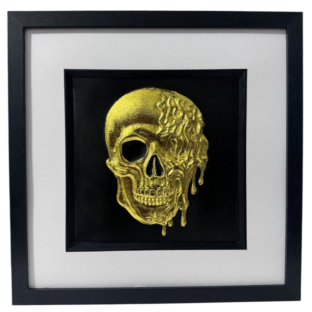 Molten dripping skull wall art in gold leaf on black background in black frame
