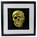 Molten dripping skull wall art in gold leaf on black background in black frame