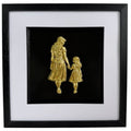 Straight-on Gold mother and daughter relief artwork with glass front, black frame and white mount.