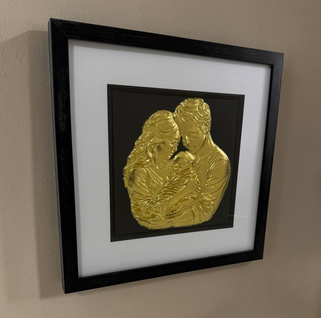Angled Gold finish family relief artwork showing black box frame, white mount and glass front.