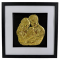 Straight-on Gold finish mum dad and baby relief artwork in a black square frame with white mount.