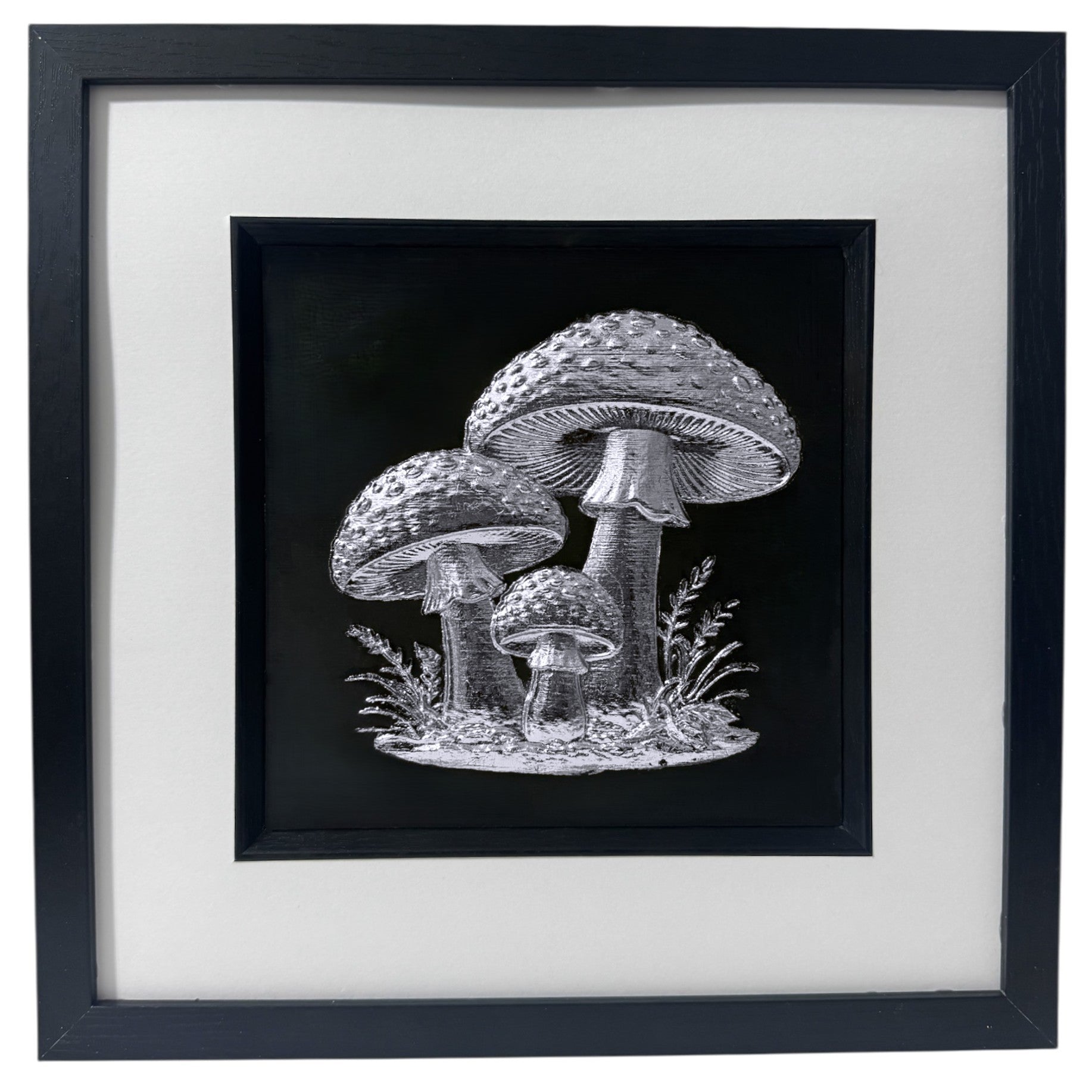Silver leaf toadstool trio wall art in black frame with white mount on black background, framed 33 x 33 cm
