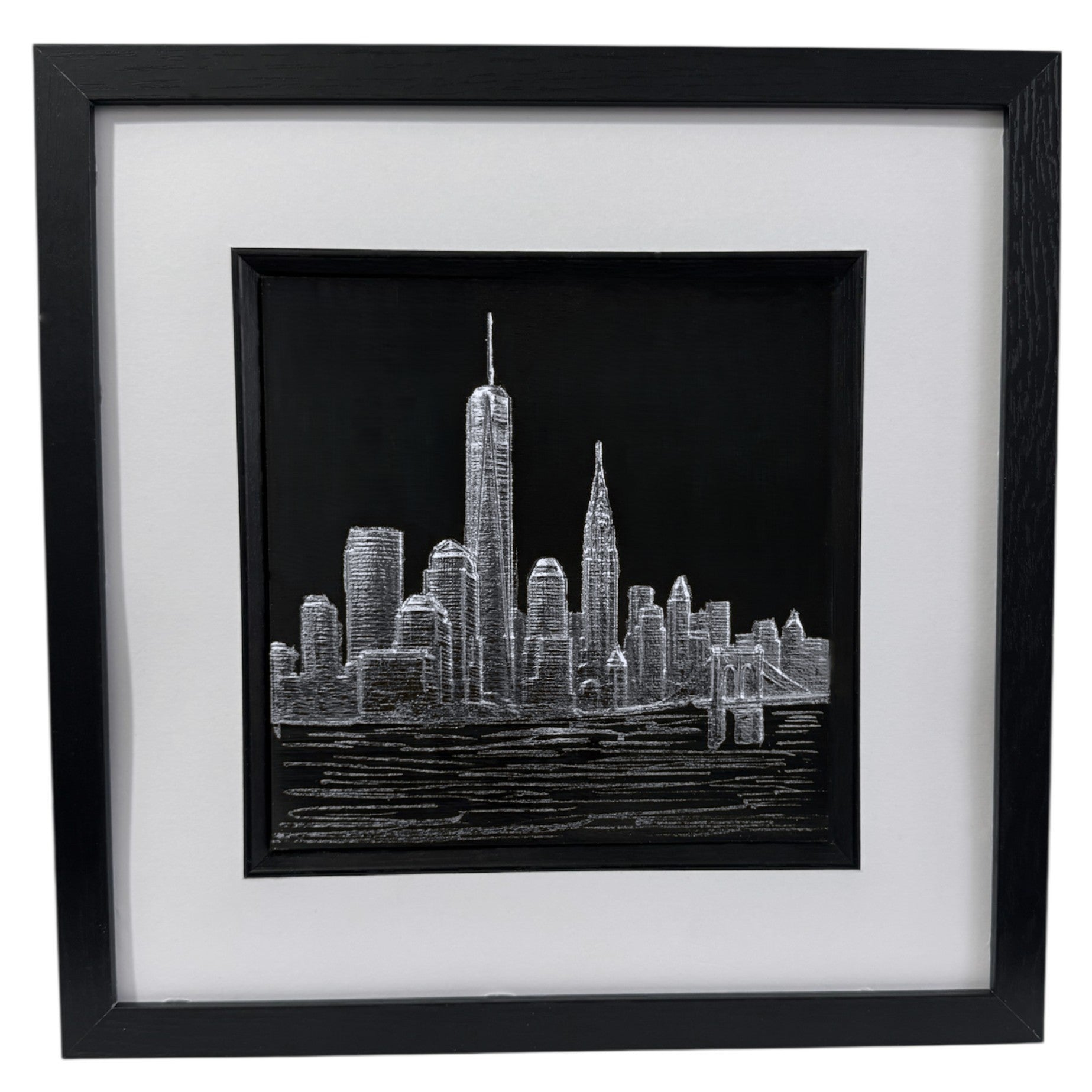 Framed New York skyline wall art in silver leaf, front-facing view highlighting raised relief cityscape design