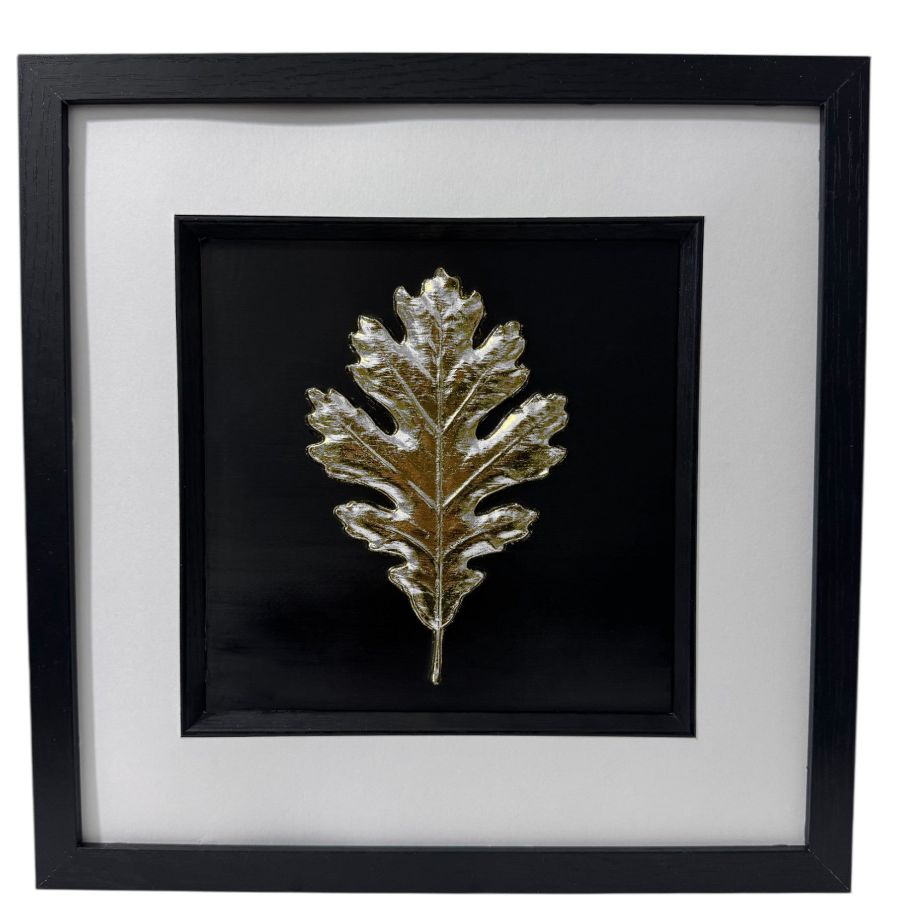 Oak leaf relief artwork finished in Silver Leaf on a black background in a black box frame with crisp white mount, front view