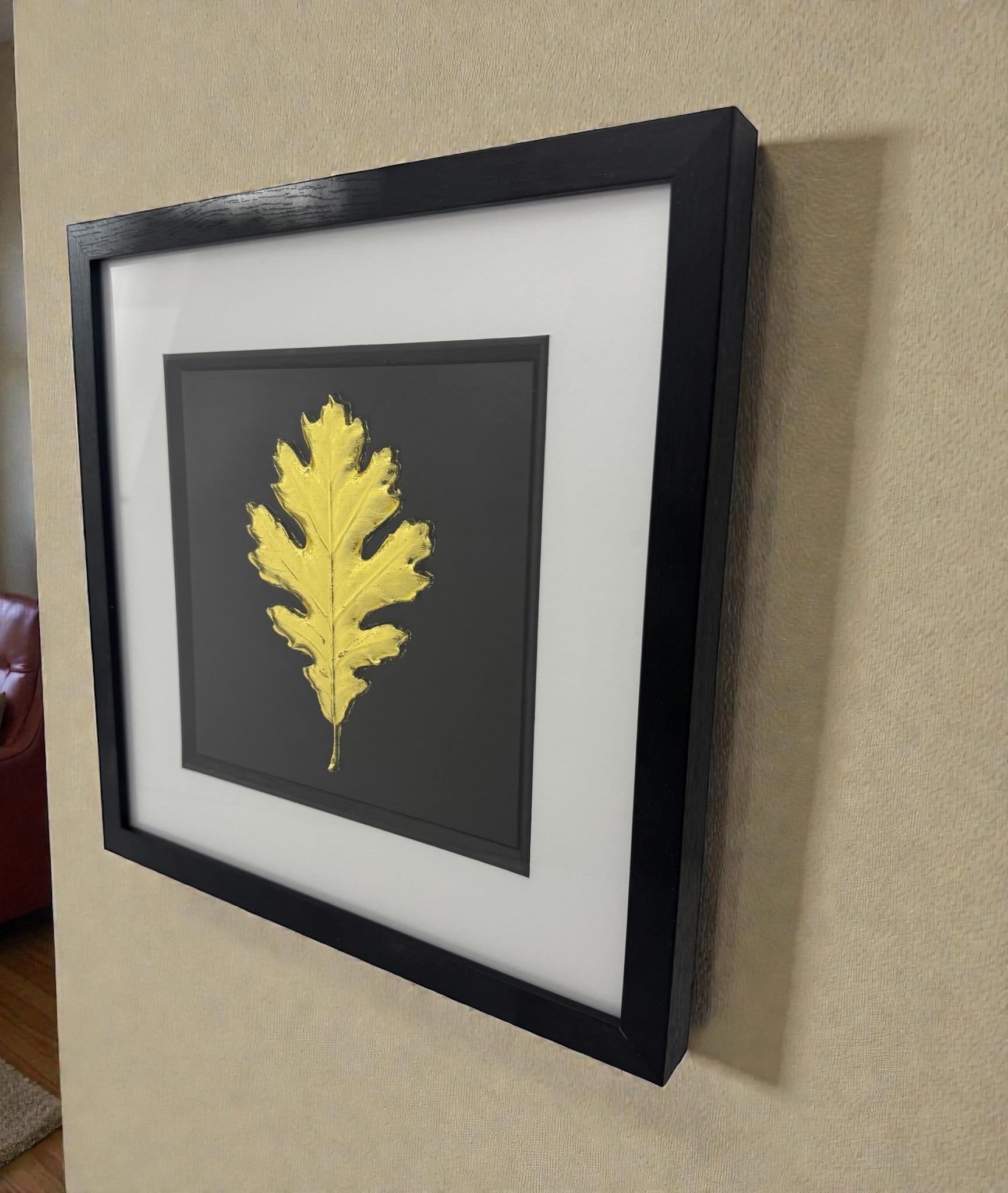 Framed oak leaf metallic relief artwork in Gold Leaf, black box frame with white mount, shown on a neutral wall