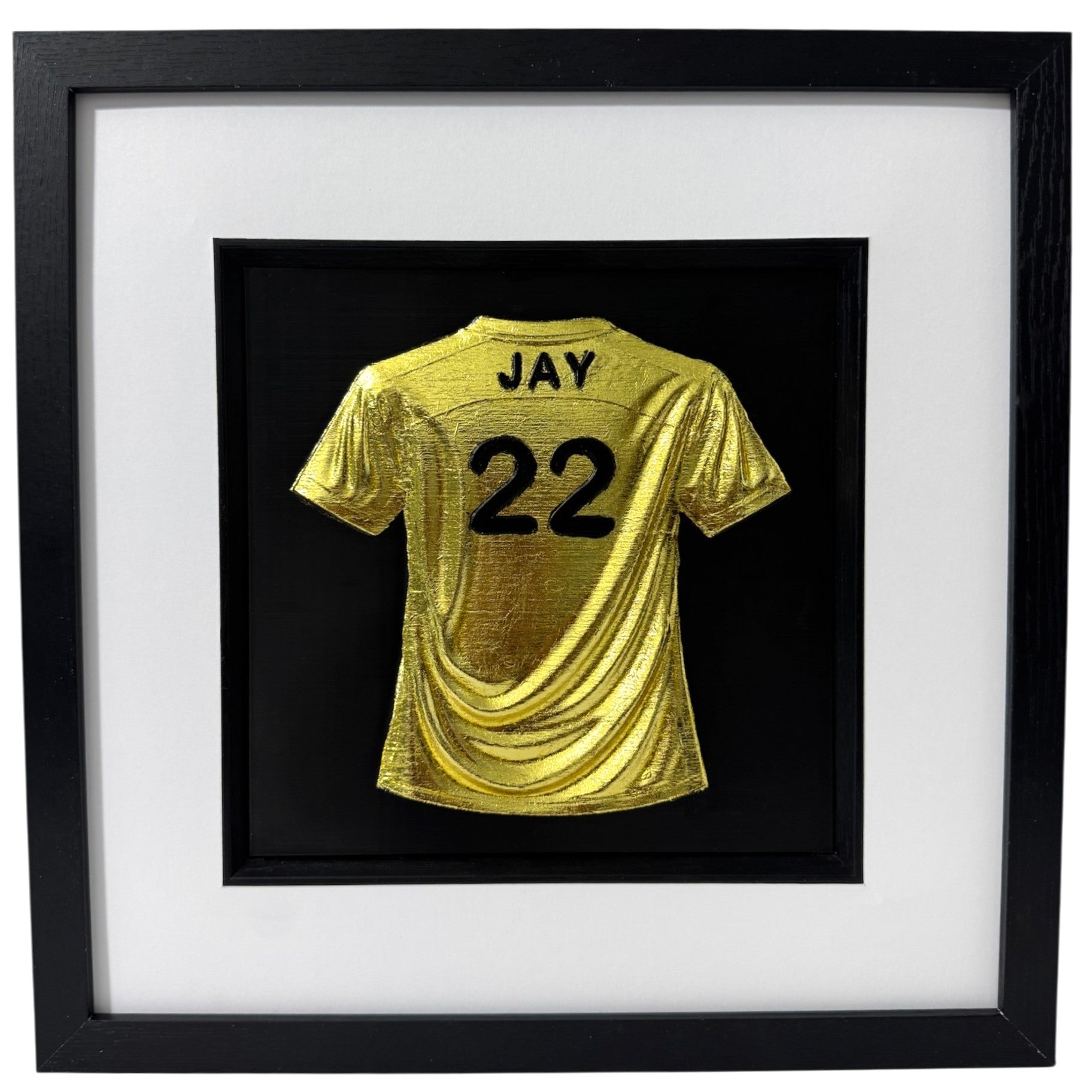 Gold 3D relief football shirt framed wall art, personalised with name JAY and number 22, black frame with white mount.