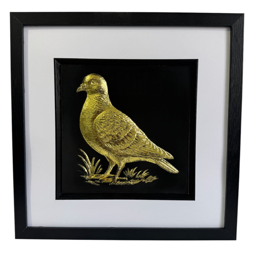 Framed pigeon wall art in gold leaf, front view showing raised relief bird design on black background with white mount