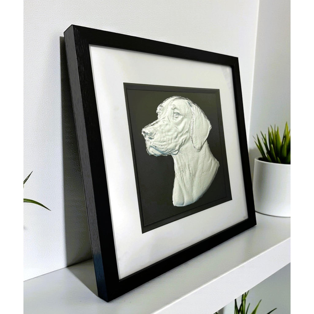 English Pointer framed wall art in silver leaf viewed at an angle, displayed in a black wooden frame with white mount
