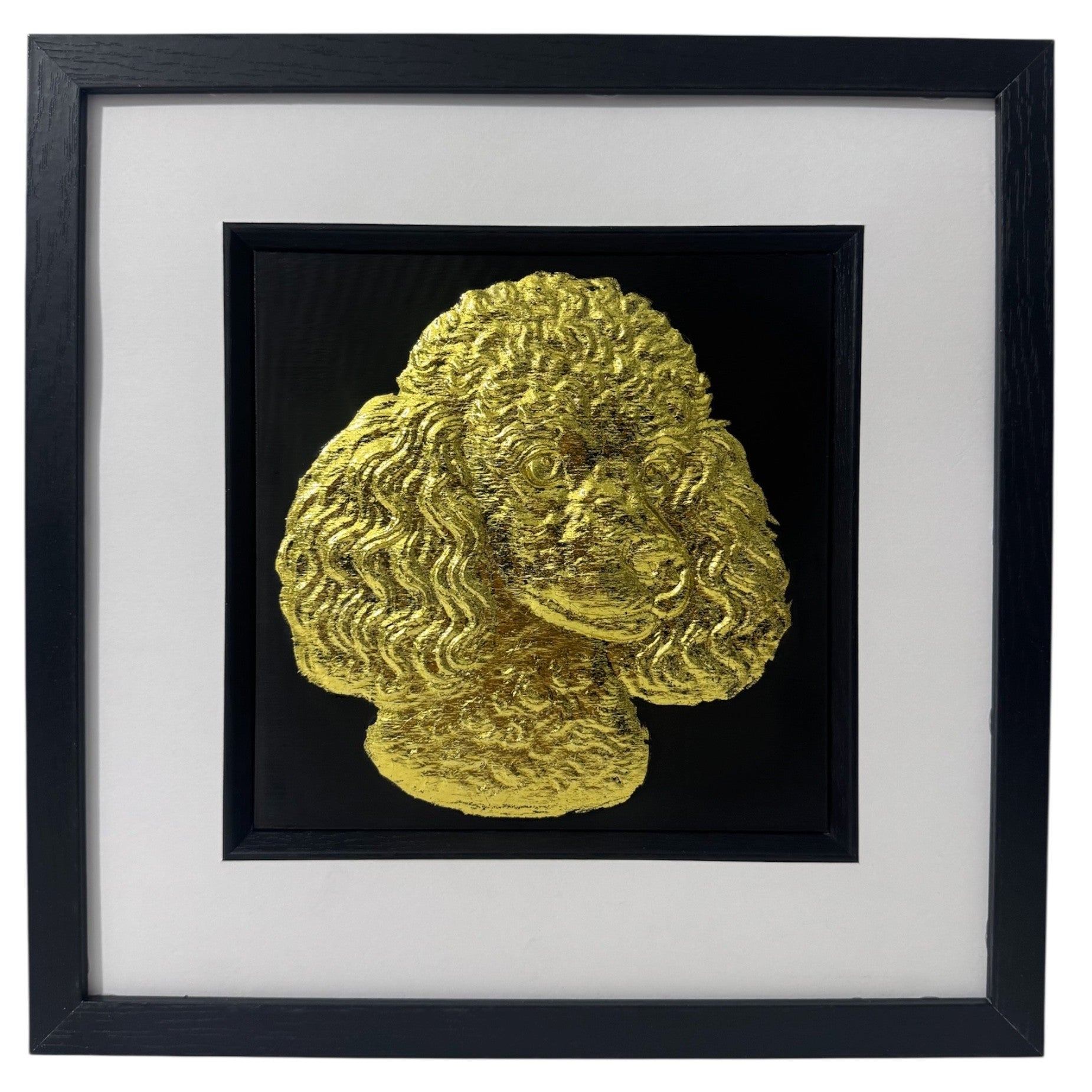 Poodle gold leaf framed wall art shown mounted on a wall at a slight angle with black frame and white mount